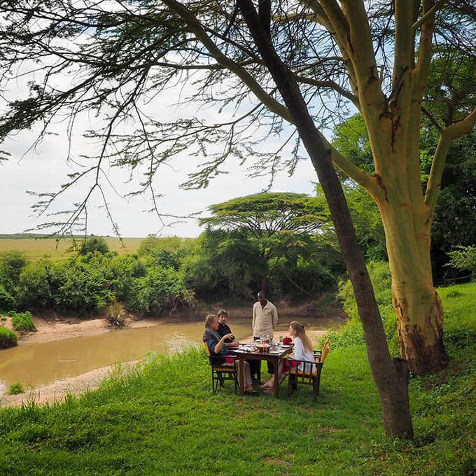 Enjoy a hearty bush breakfast overlooking the Masai Mara National Reserve