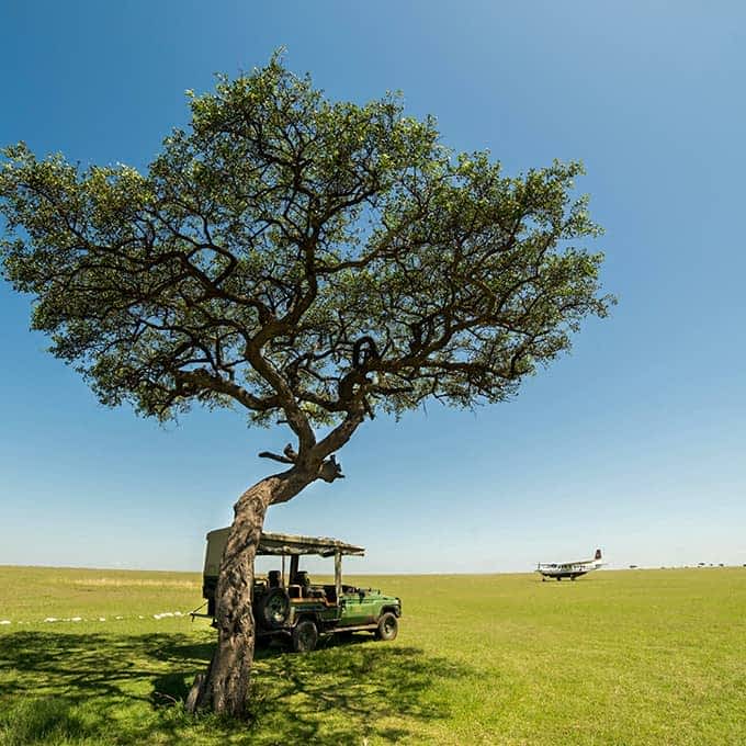 Aircraft and safari vehicle on the airstrip in Olare Motorogi